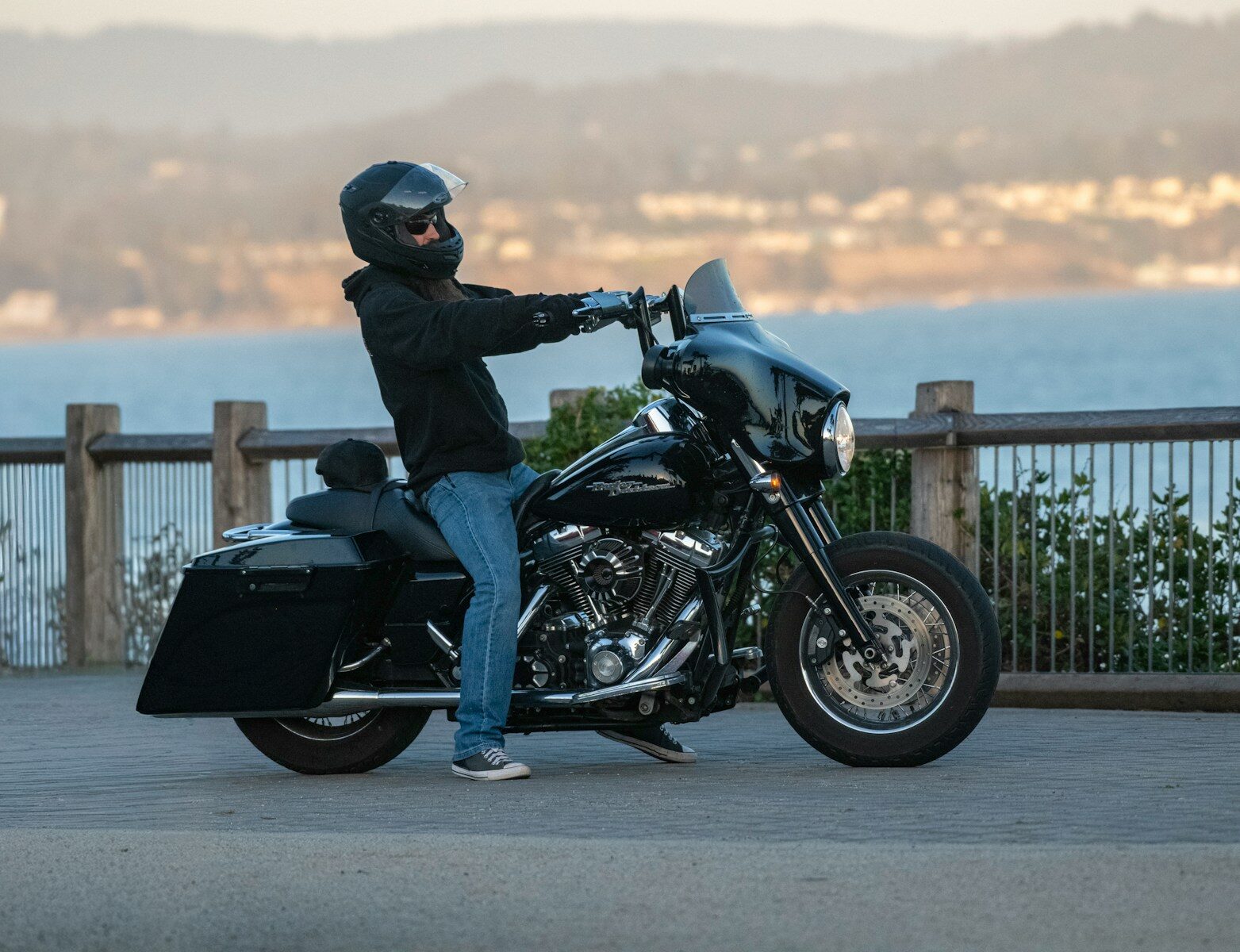 Rider on a black motorcycle by the water